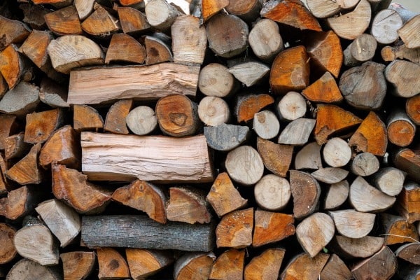 Close-up of a stacked pile of mixed split firewood