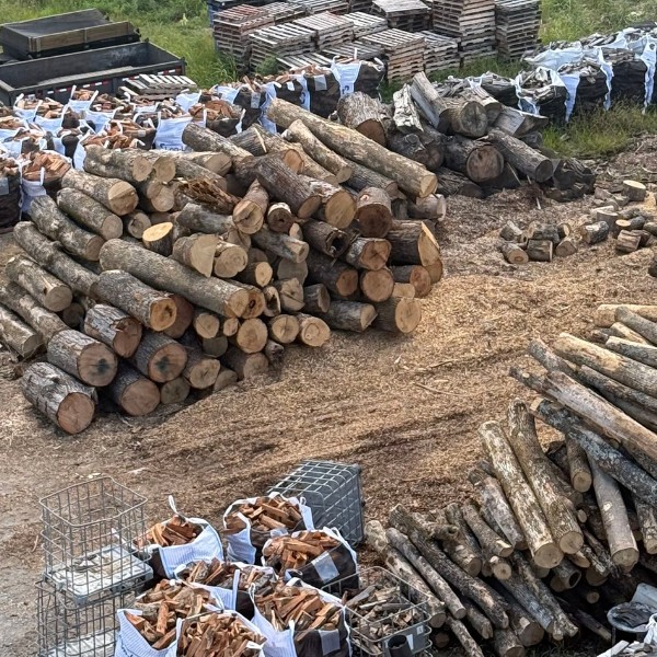 Bagged and stacked firewood bundles at a wood processing yard