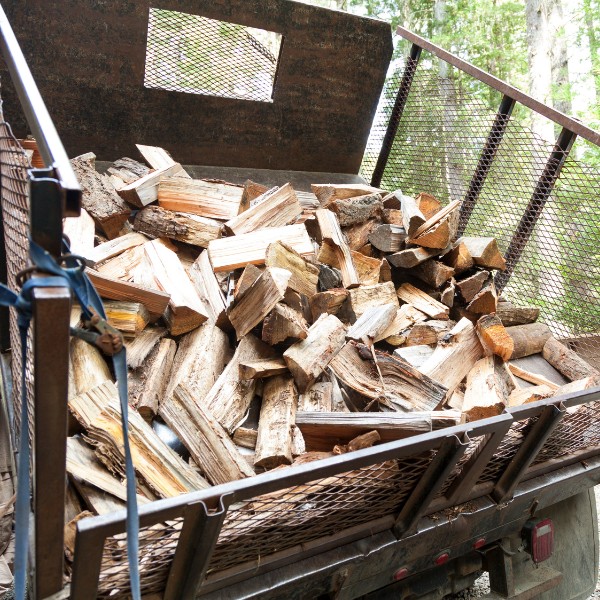 Truck bed filled with split firewood ready for delivery