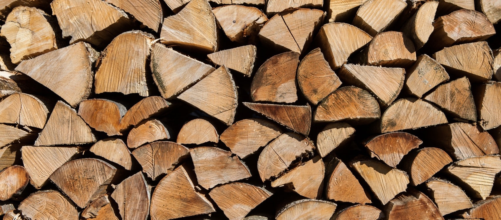 Close-up of neatly stacked split firewood logs